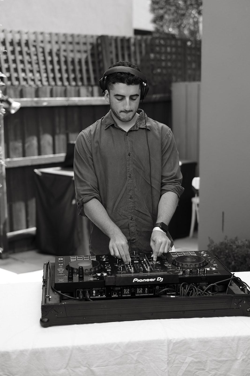 Benj cueing the next track behind the decks