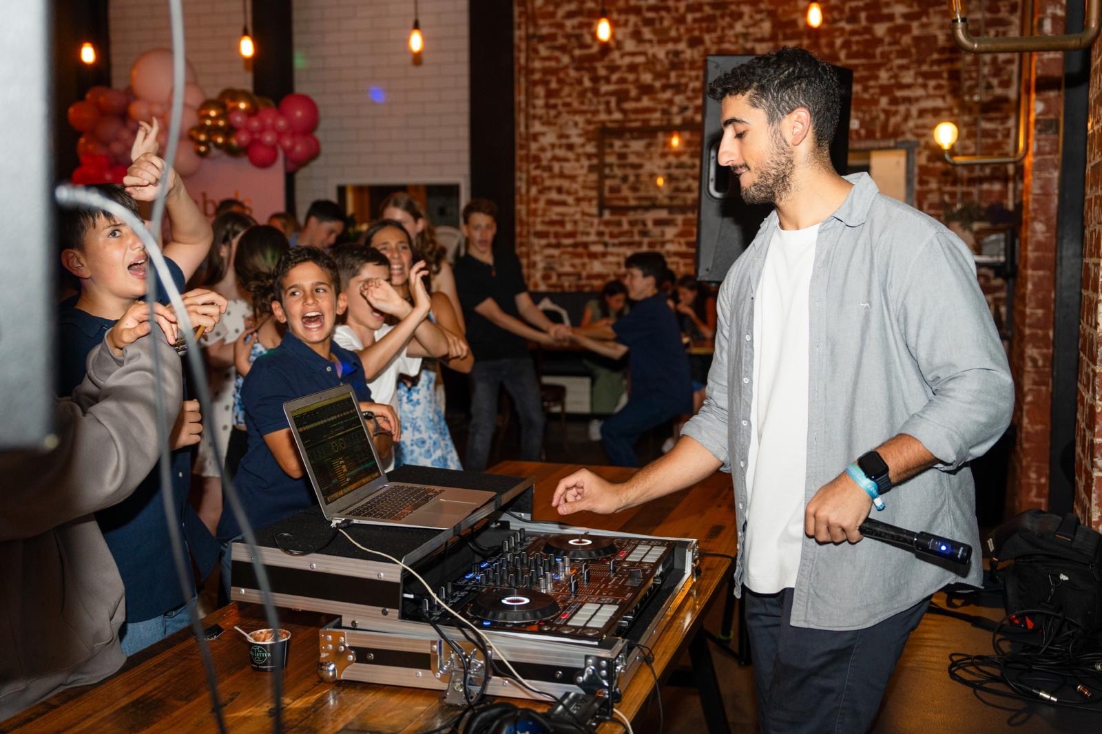 A packed floor singing along at a bar mitzvah